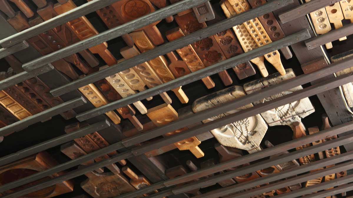 御菓子司‧本家菊屋　本店。天井には歴史の重みを感じるのお菓子の木型が並べられている